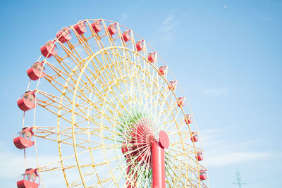 Low angle view of ferris wheel against sky