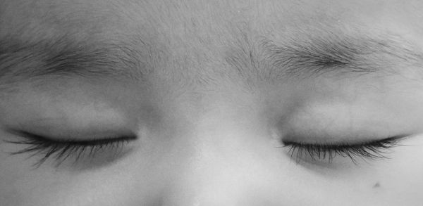 Cropped image of baby with eyes closed