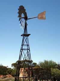 Low angle view of traditional windmill against clear blue sky