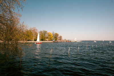 Sailboat on sea against clear sky