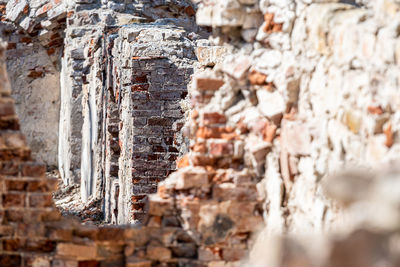 Close-up of a fragment of the ruins of an old stone building on a sunny day, selective focus