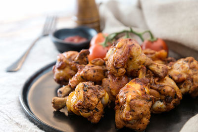 Close-up of chicken lollipops in plate on table