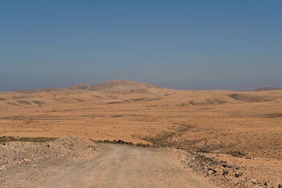 Scenic view of desert against clear sky