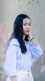 Young woman wearing hat standing outdoors