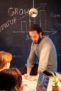 Boy drawing on blackboard