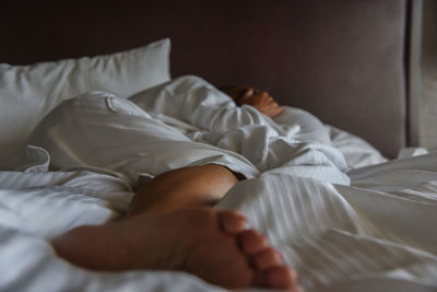 Woman sleeping on bed at home