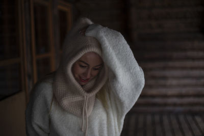 Portrait of young woman standing outdoors