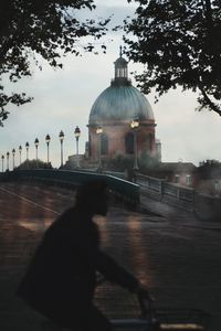 Rear view of man in temple against sky