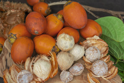 Ripe betel nut or areca nut with betel leaf isolated on wooden background.