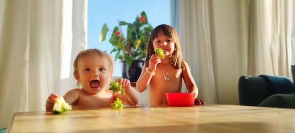 Portrait of woman eating food at home