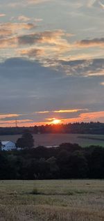 Scenic view of field against sky during sunset