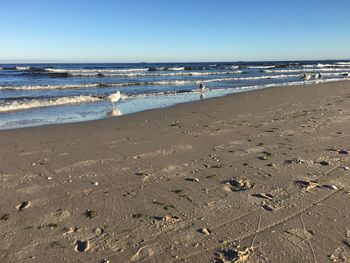 Scenic view of beach against clear sky