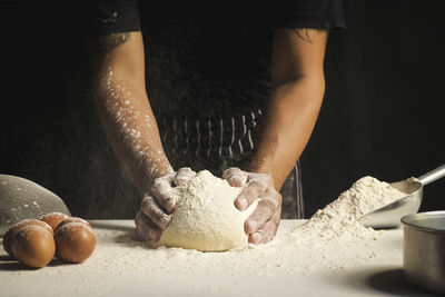 Midsection of man preparing food in kitchen