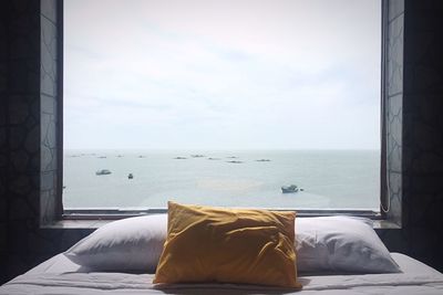 Close-up of sea against sky seen through window