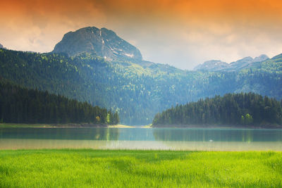 Scenic view of lake and mountains against sky