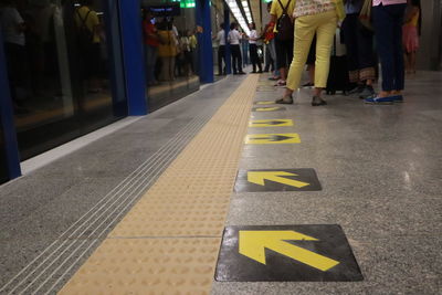 Low section of people standing on road