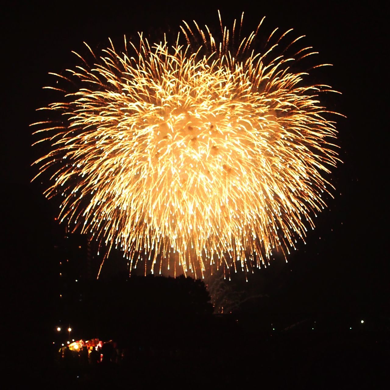 night, celebration, illuminated, firework display, long exposure, exploding, glowing, arts culture and entertainment, low angle view, motion, firework, firework - man made object, sky, sparks, event, entertainment, dark, outdoors, scenics, multi colored, city life, vacations, bright, tourism, explosion