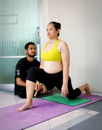 Young woman exercising in gym