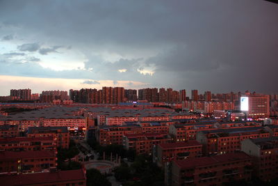 Buildings against cloudy sky