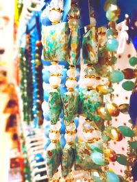 Close-up of decorations hanging in store for sale