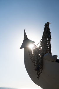 Low angle view of silhouette sculpture against clear sky