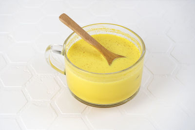 Glass of golden milk with spices and turmeric powder. healthy drink moon milk.