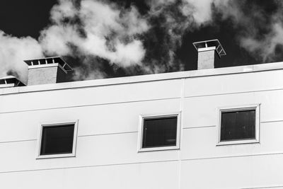 Low angle view of building against sky in black and white mode 