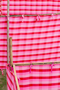 Close-up of clothes drying against pink wall