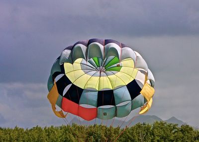 Low angle view of parachute against sky