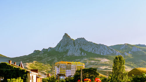 Scenic view of mountains against clear blue sky