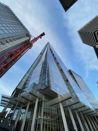 Low angle view of buildings against cloudy sky