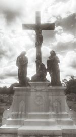 Low angle view of statue against cloudy sky