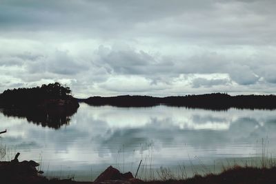 Scenic view of lake against cloudy sky