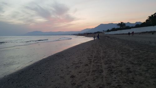 Scenic view of beach against sky during sunset