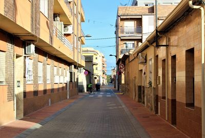 Narrow alley along buildings