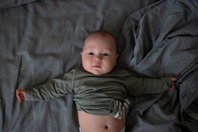 Portrait of cute baby boy sleeping on bed at home