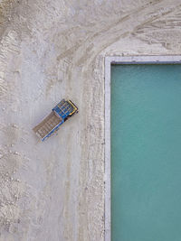 Maldives, kaafu atoll, himmafushi, aerial view of empty truck parked at edge of sandy island