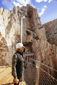 Rear view of man standing on rock