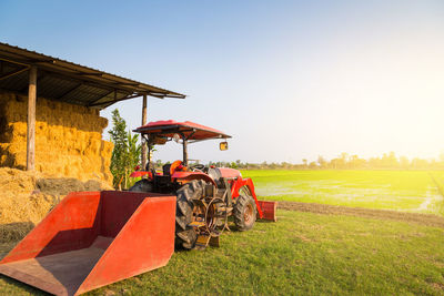 Tractor on field against clear sky