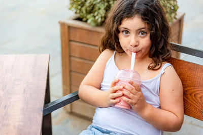 Midsection of a woman drinking glass