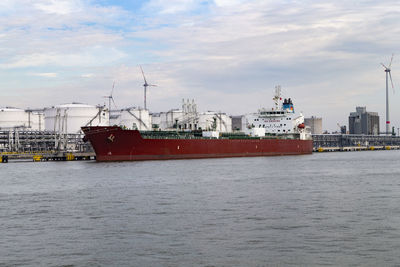 Ship at harbor against sky