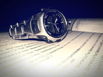 High angle view of clock on text