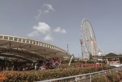 Low angle view of ferris wheel against sky