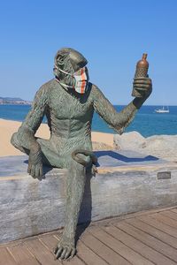 Man standing on beach against clear sky