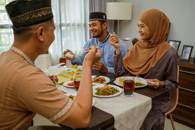 Happy couples having food at home