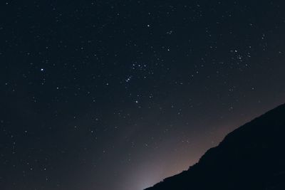 Low angle view of silhouette stars against sky at night