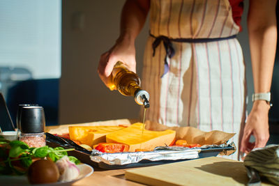 Midsection of woman holding wineglass