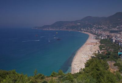 High angle view of sea and cityscape against sky