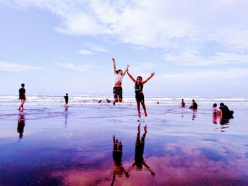 Full length of kids jumping on beach