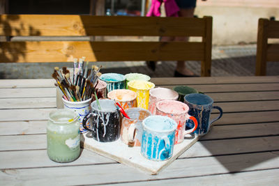 Close-up of water color in cups at table